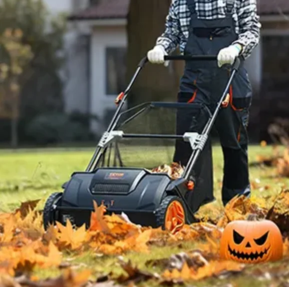 man mowing the lawn with yellow leaves